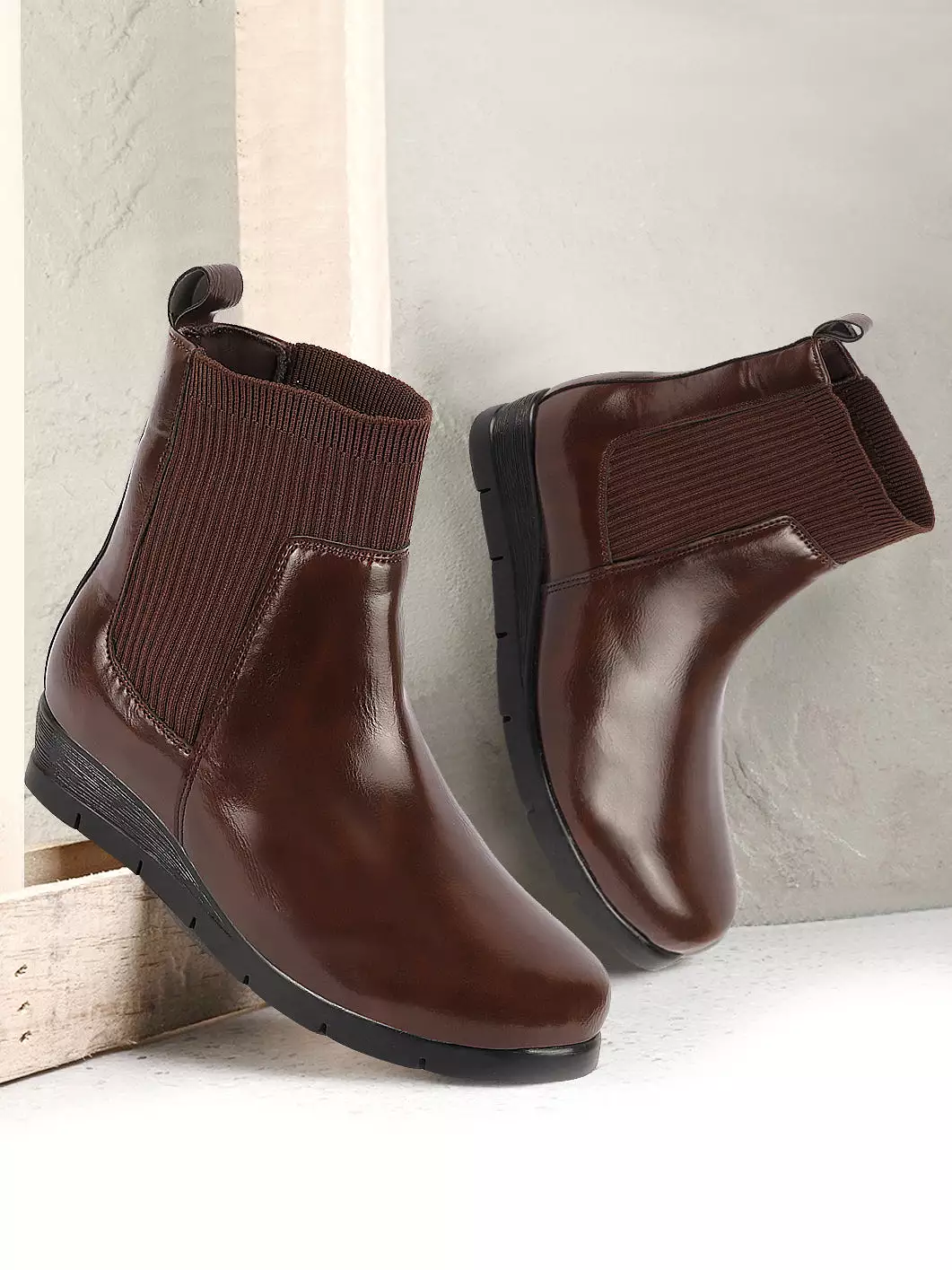 Brown women's slip-on wedge heel Chelsea boots with mid top socks collar, designed for broad feet.