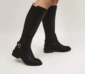 Knee-high black boots with harness detail for women to wear in the office in the style of a rider.