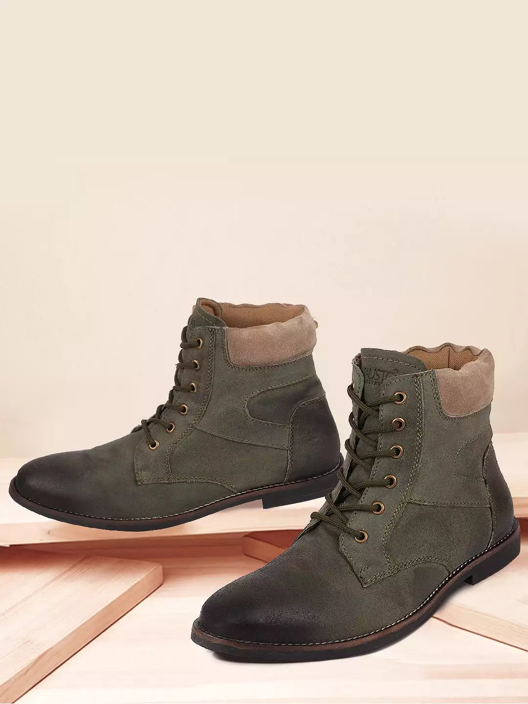 Olive leather boots for men with mid-top lace-up design.