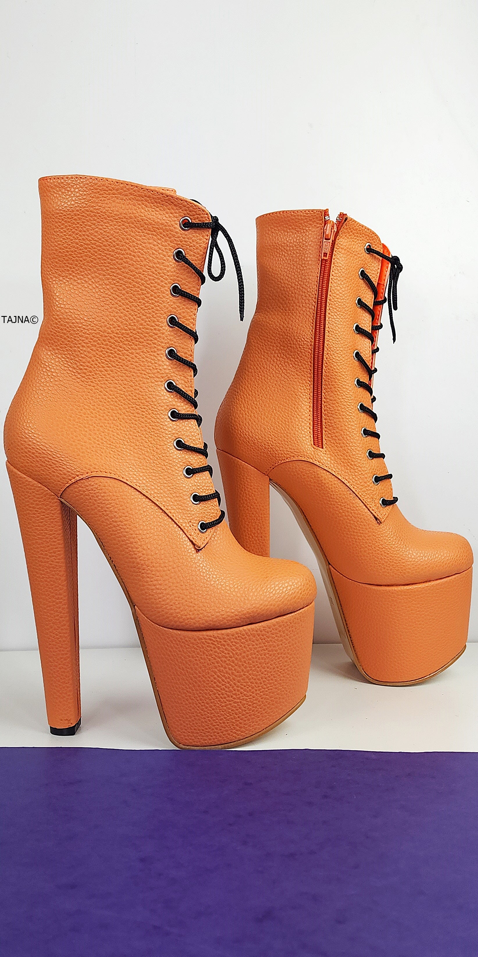 Orange lace up chunky heel boots.