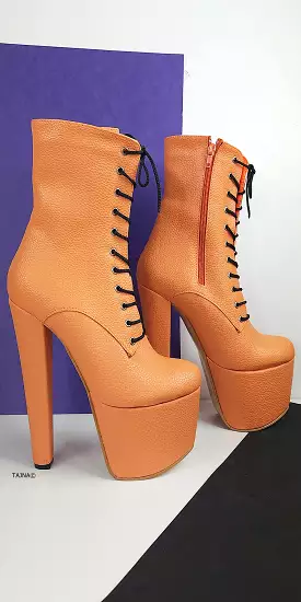 Orange lace up chunky heel boots.