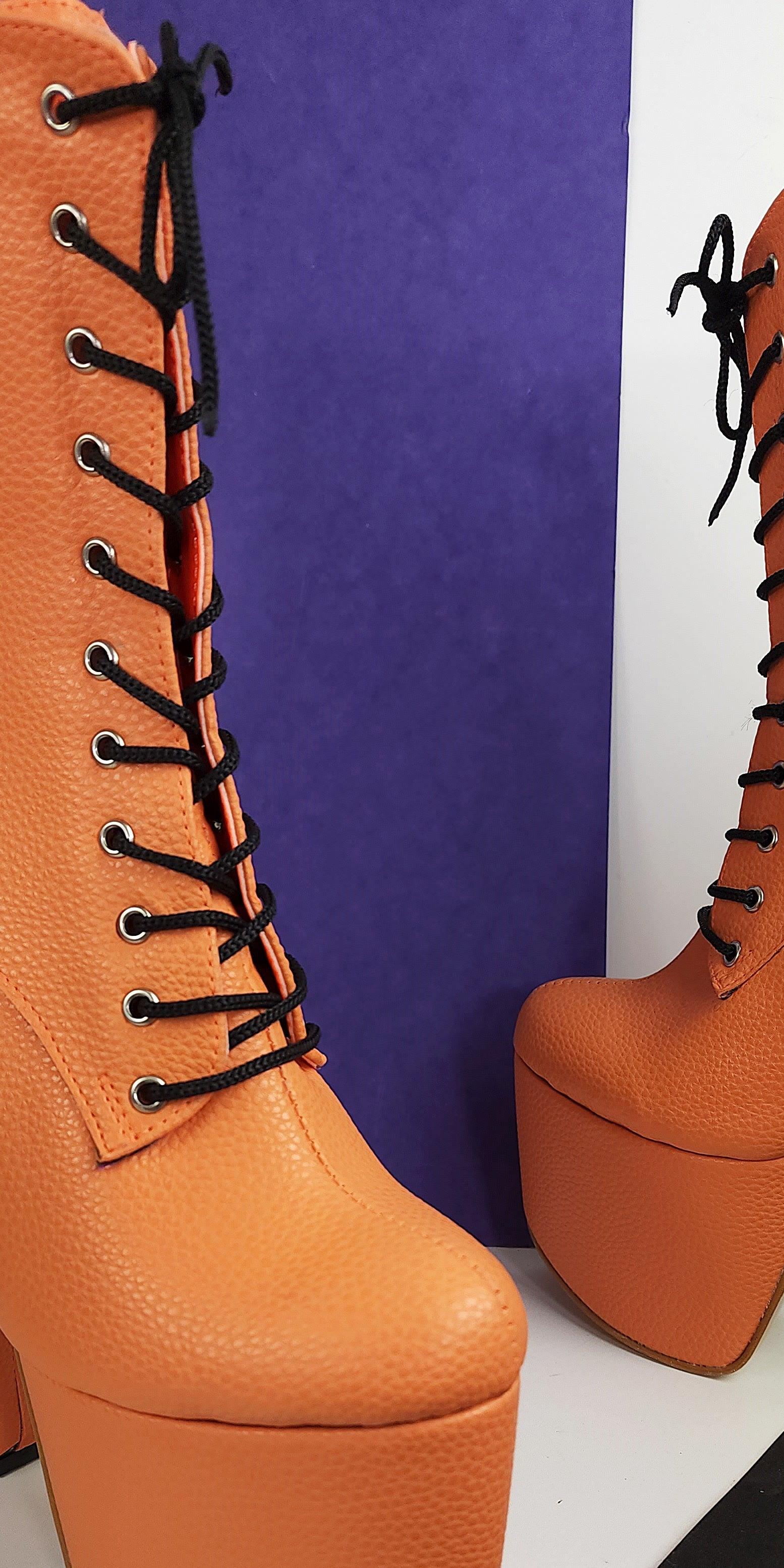 Orange lace up chunky heel boots.