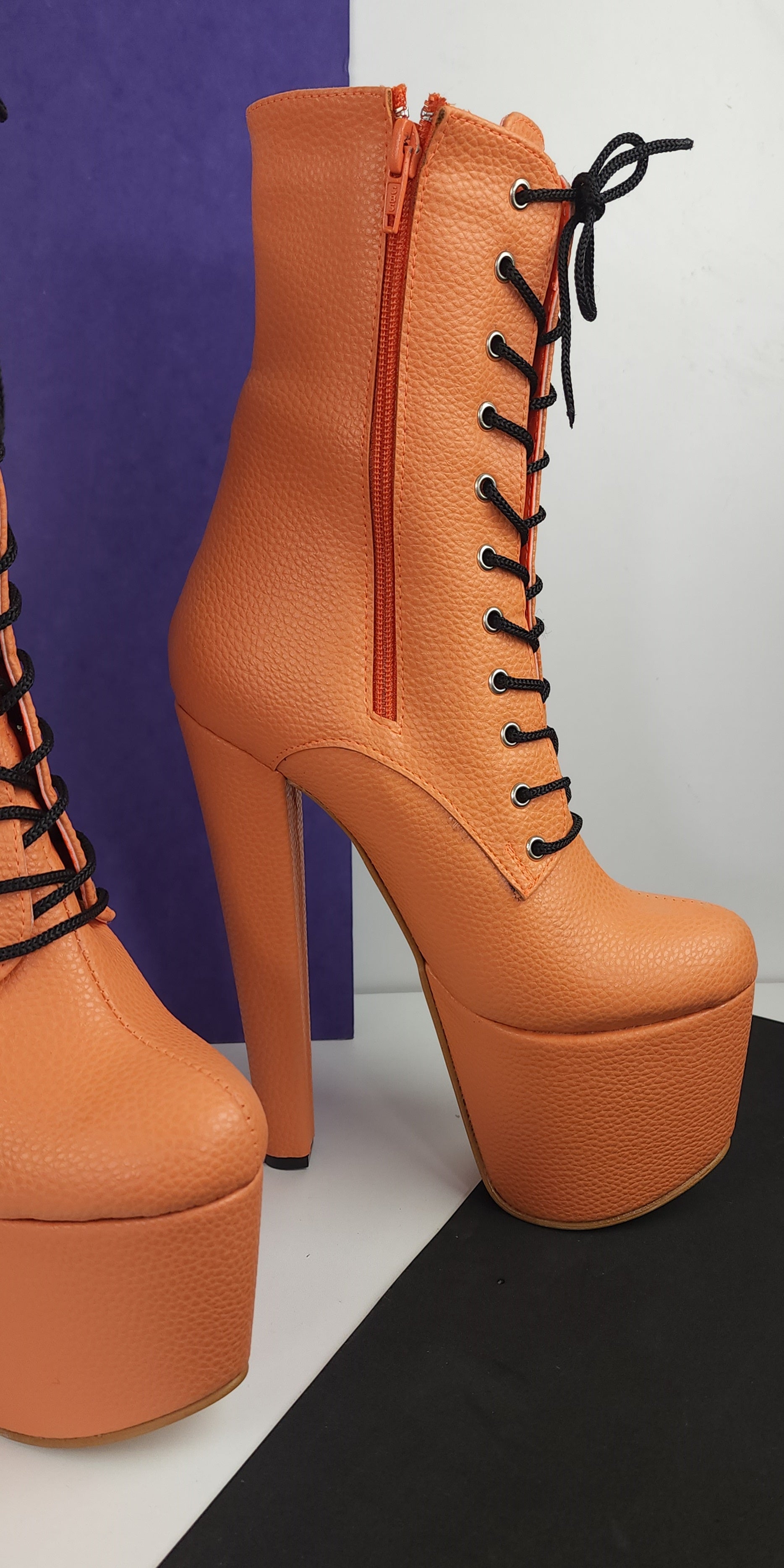 Orange lace up chunky heel boots.