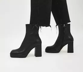 Women's black leather platform ankle boots with square toe for office attire.