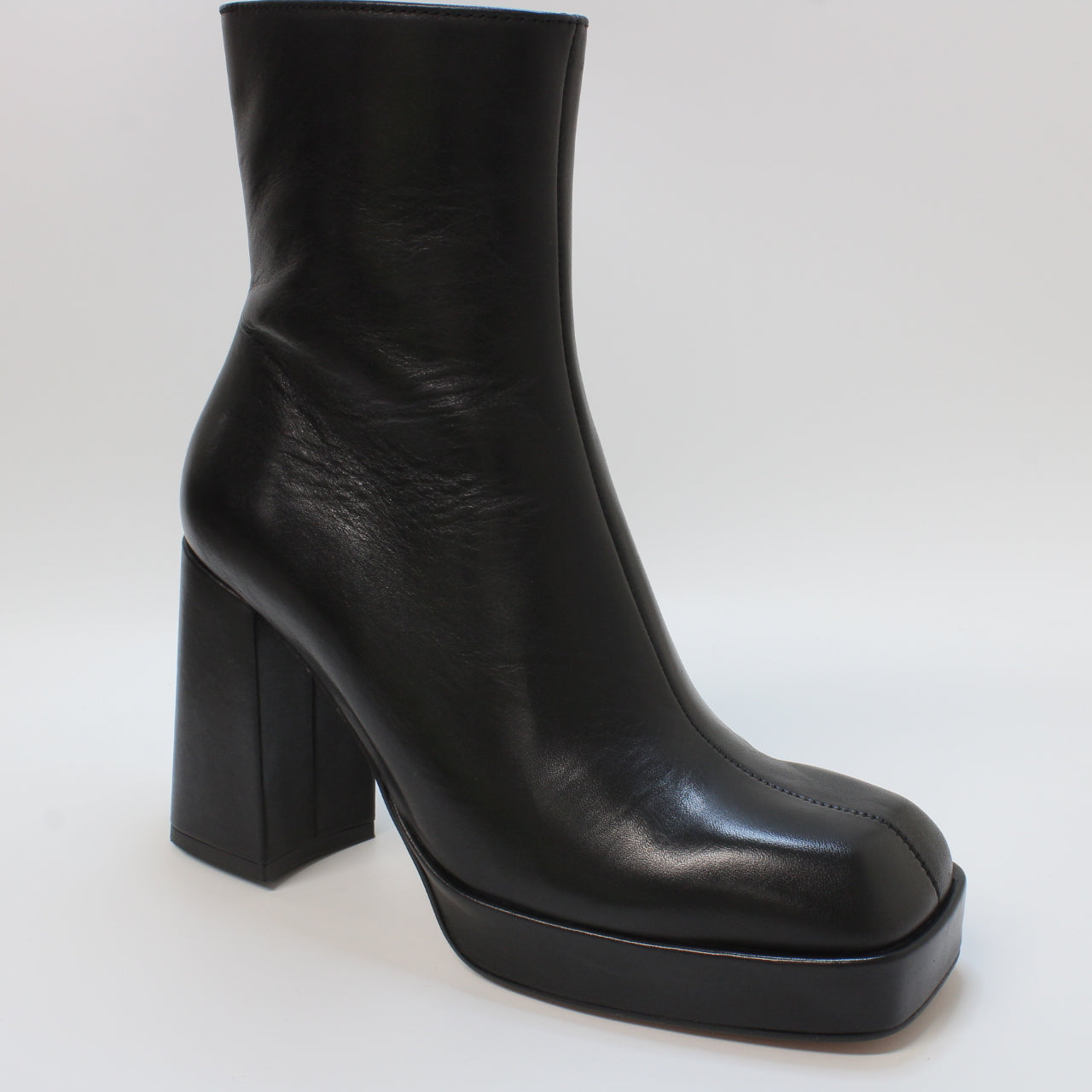 Women's black leather platform ankle boots with square toe for office attire.